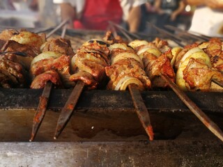 Shashlik preparing on a barbecue grill over charcoal. Shashlik or Shish kebab popular in Eastern Europe.