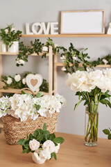 Floral background. Flower shop interior. Floral design studio, making decorations and arrangements. Flowers delivery service and sale of home plant, creating order. Peonies and roses.