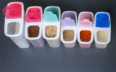 Set of plastic cans with various raw cereals. Kitchen cereal storage container