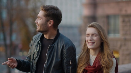 Obraz premium Romantic couple dating outdoors. Beautiful man and woman walking on city street