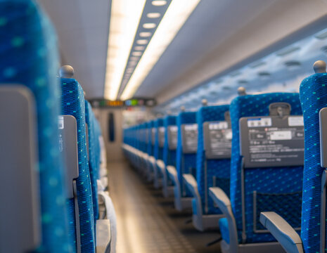 Looking down the aisle of Commuter Train in Japan with empty seats due to Covid 19. Pandemic has hurt all transportation industries globally.