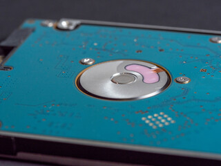 2.5 inch hard disk drive for laptop or computer on a dark paper background. close up, selective...