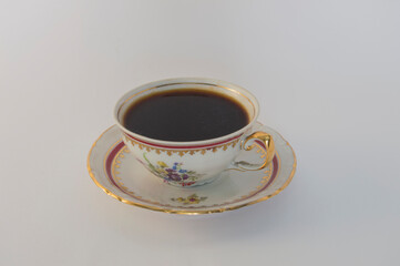 fine porcelain  cup with black coffee isolated on  white background