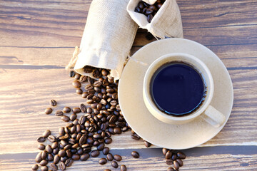 Top view coffee cup and coffee beans on wood table, space for text