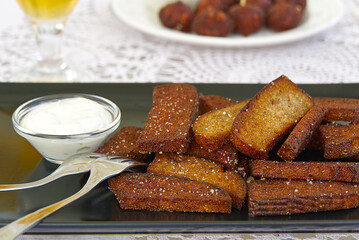 Garlic and black bread snacks with sour cream and greens sauce. perfect snacks with beer.