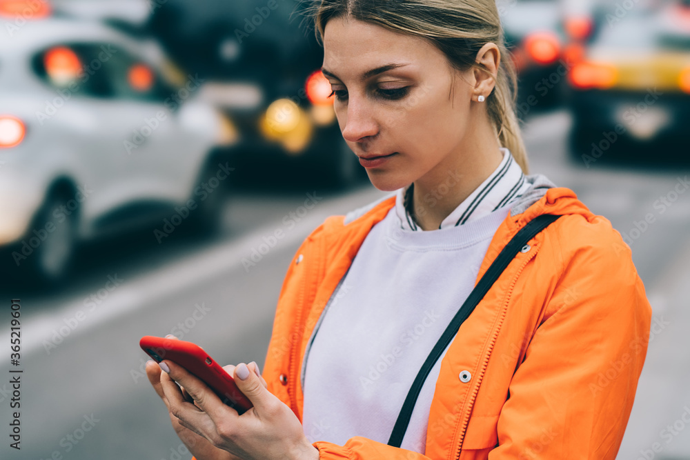 Aufkleber close up view of young female using mobile phone data internet connection while standing on city str