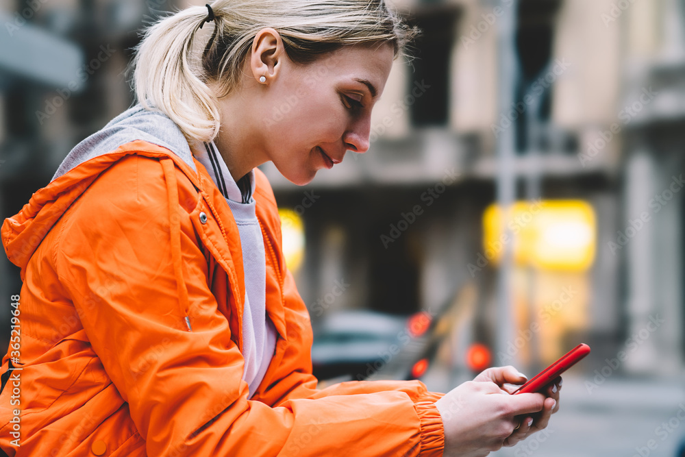 Aufkleber close up view of young female using mobile phone data internet connection while standing on city str