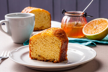.Homemade orange cake. Table with a piece of cake and cup of coffee