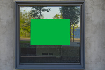 chroma key advertising sticker on the window. well suited for real estate listings. Blank chroma key billboard and outdoor advertising. Mockup poster outside.