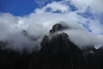 Majestic mountain peaks covered under clouds