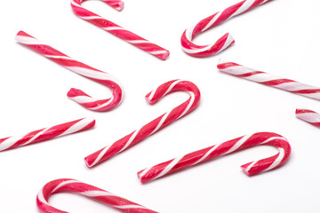 Multiple Christmas candy canes on a white isolated background white / red Christmas candies. candy pattern, pattern, greeting card, wallpaper, wrapping paper