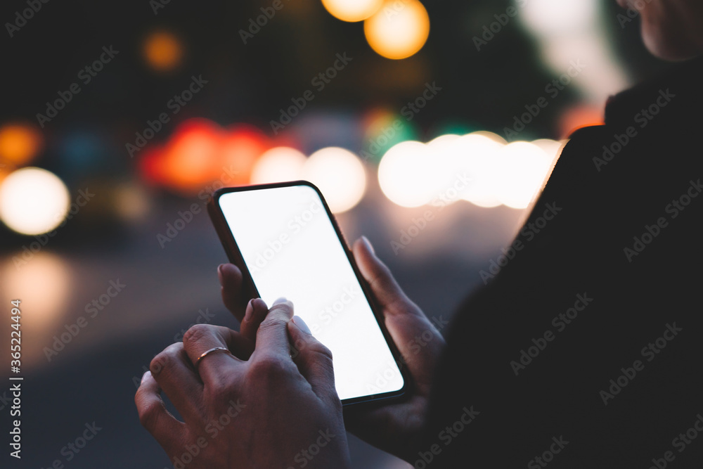 Poster cropped view of young woman holding smartphone with blank screen area for your internet content on b