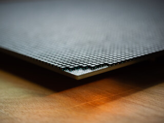 Closeup of corner of an LED video screen with shallow depth of field and some emitters removed