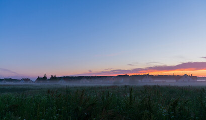 Naklejka na ściany i meble foggy sunrise over the field