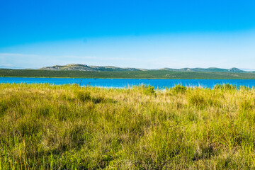 Beautiful meadow and green lake in ornithological nature park Vrana (Vransko jezero) in Dalmatia, Croatia