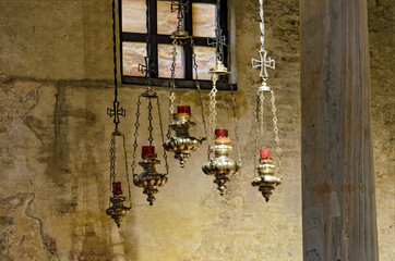 Traditional hanging glowers made from brass in a church
