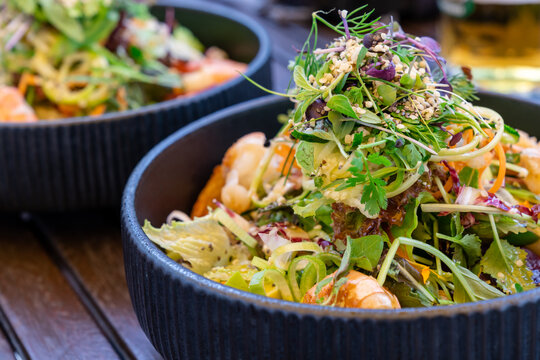 close up view of delicious and healthy summer greens salad with shrimp