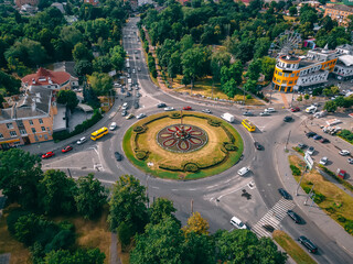 Aerial view of roundabout road with circular cars in small european city at summer afternoon © onphotoua