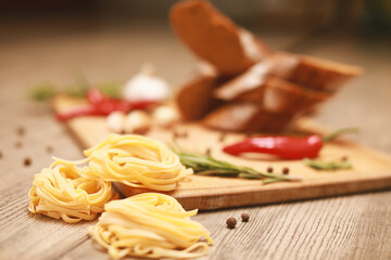 view from the top on fresh homemade bread with fettuccine and rosemary on wooden cutting board 