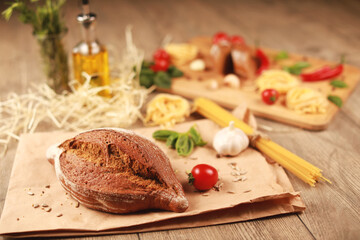 close up view on bread with tomato and rosemary, garlic,basil,spaghetti,sunflower oil and rosemary on background 