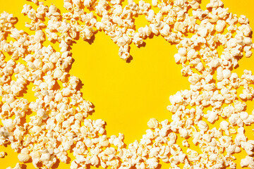 Heart shaped popcorn on a yellow background. Flat Lay Style
