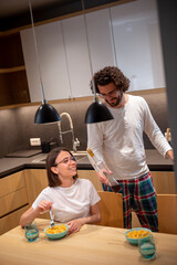 Couple having fun while eating dinner at home
