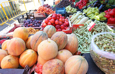 Variety of fresh fruits and vegetables on a farmer market.