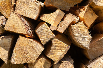 Dry birch firewood stacked for fireplace and stove. Close up view. Wooden background.