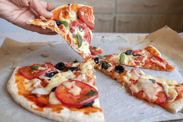 take a slice of homemade pizza with melted cheese and tomatoes