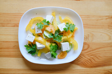 Greek salad with curd cheese on a plate.
Fresh summer salad with feta cheese.
Bright vegetables in...