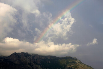 Beautiful clouds and rainbow over the mountain Demerdzhi in Crimea