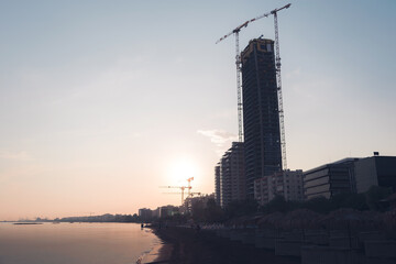 Beach in Limassol with high-rise building construction site