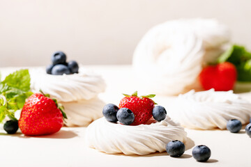 Dessert pavlov with strawberries and blueberries
