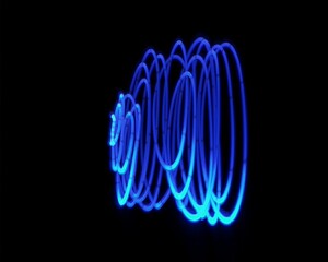 Light painting design. Combination of sky blue and white light against a black background 