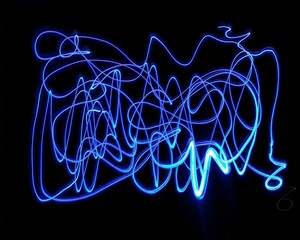 Light painting design. Combination of sky blue and white light against a black background 