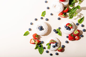 Dessert pavlov with strawberries and blueberries