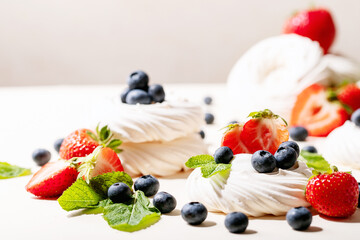 Dessert pavlov with strawberries and blueberries