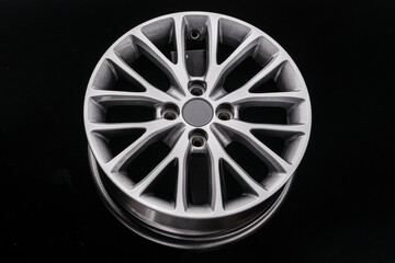 multi-spoke gray alloy wheel on black background
