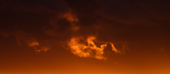 Dramatic orange evening sky with clouds at sunset