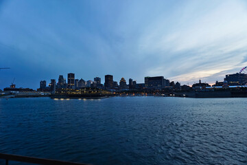 Montreal Downtown skyline during the twilight blue hour. Foreground is Saint Laurent river.