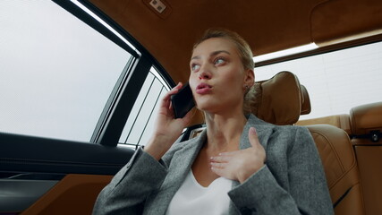 Stressed business woman talking phone at car. Woman arguing on phone at car