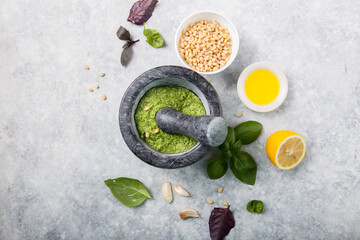 Making Pesto. food cooking and culinary concept -  pine nuts, olive oil  and garlic for basil pesto...