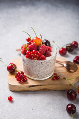 Chia pudding with cherry, raspberry, currant in glass bowl