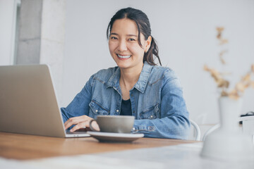 using computer.woman typing keyboard laptop online chatting search form internet while working sitting at coffee shop.concept for.technology device contact communication business people