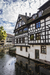 Fototapeta na wymiar Nice houses in Petite-France (Little France) and River Ill in Strasbourg. Petite-France is an historic area in the center of Strasbourg. Alsace, France.