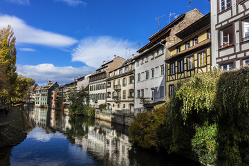 Fototapeta na wymiar Nice houses in Petite-France (Little France) and River Ill in Strasbourg. Petite-France is an historic area in the center of Strasbourg. Alsace, France.