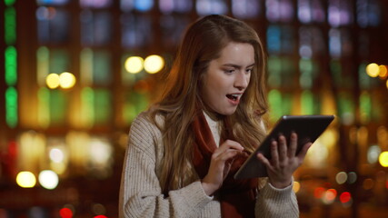 Happy lady receiving message tablet outside. Excited girl looking tablet screen