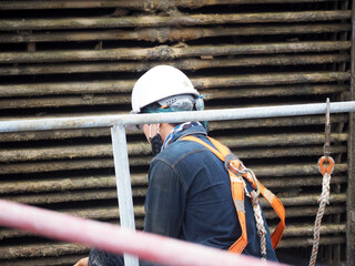 Man Working on the Working at height on construction site with blue sky