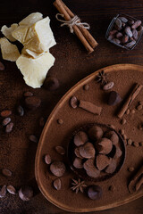 healthy delicious chocolate truffles around ingridients with natural cocoa beans,  powder, cacao butter, cane sugar. healthy sweets concept. flat lay