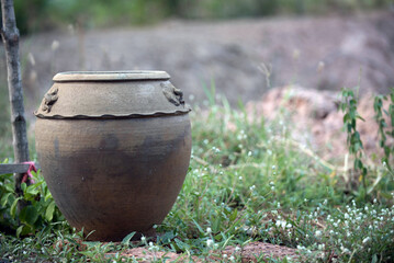 Fototapeta premium Old pottery with water in the garden